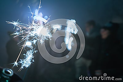 Silvester sparkler at night with people, Wunderkerze Stock Photo