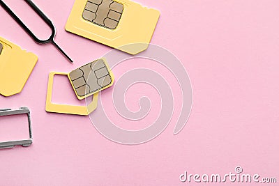 SIM card, tray and ejector on pink background, flat lay. Space for text Stock Photo