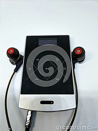 A simple audio setup comprises of ear phones, music player and amplifier Stock Photo