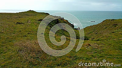 Minimalist countryside cliff leading to distant ocean Stock Photo