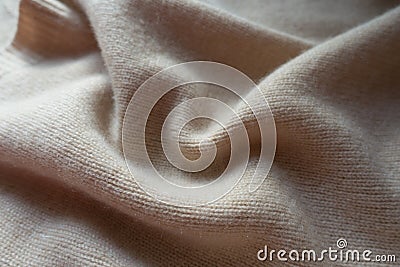 Simple beige knitted fabric in folds Stock Photo