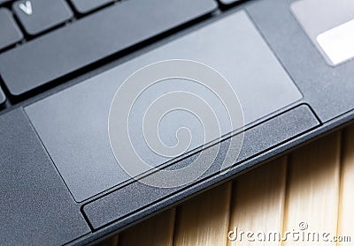 Simple black laptop trackpad, modern touchpad with physical buttons top view, closeup. Netbook track pad top view, from above Stock Photo