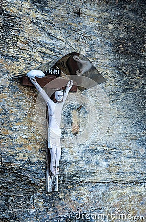 Simple catholic crucifix on a granite wall Editorial Stock Photo