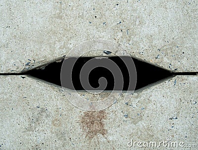 A simple cement sewer hole forms a wide hexagon shape Stock Photo