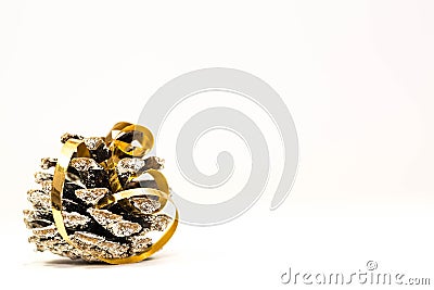 Simple Christmas image, pine cone with golden ribbon close up shot Stock Photo