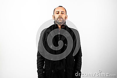 Simple and clean portrait of middle-aged man wearing his black raincoat to hide his face Stock Photo