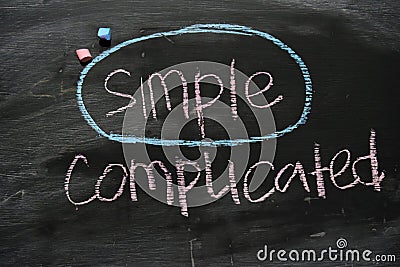 Simple or Complicated written with color chalk concept on the blackboard Stock Photo