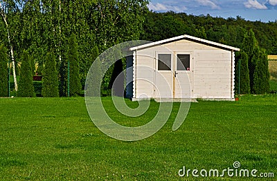New garden house or shed in green lawn or grass Stock Photo
