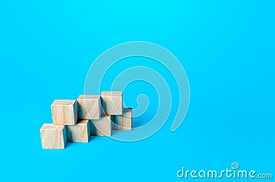 Simple cubic shape assembled from blocks on a blue background. Minimalism. Simple shapes geometry. Slide for presentation Stock Photo