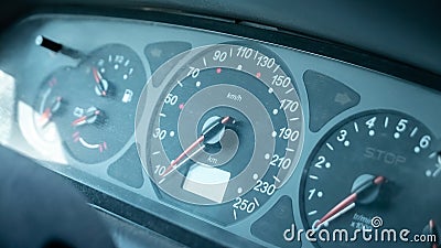 A simple dusty old speedometer in a generic motionless stopped car interior, object detail, closeup, vehicle dashboard dials Stock Photo