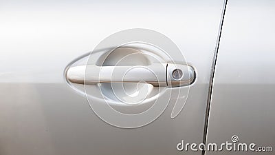 Simple generic silver car door handle with a key lock hole, side front view, object detail, closeup, vehicle doors handle frontal Stock Photo