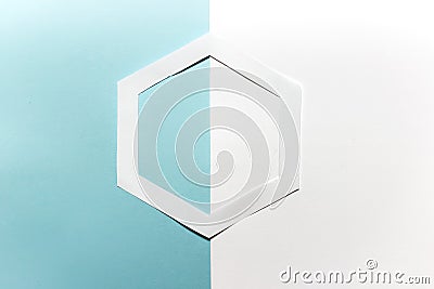 Simple hand cut paper origami hexagon shape on blue white background Stock Photo