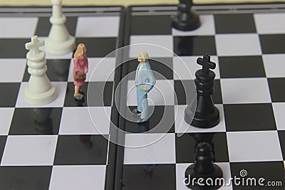 Simple illustration for photo War, Battle or politic situation concept, 2 standing mini figure, man and woman negoitation or Stock Photo