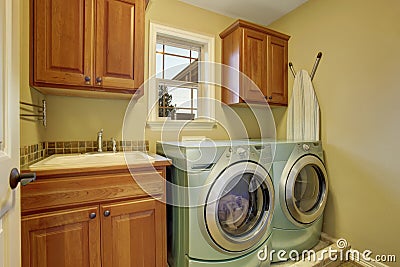 Simple laundry room with tile floor. Stock Photo