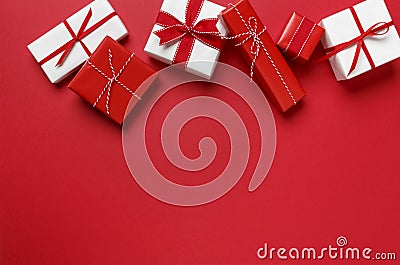 Simple, modern red & white Christmas gifts presents on red background. Festive holiday border. Stock Photo