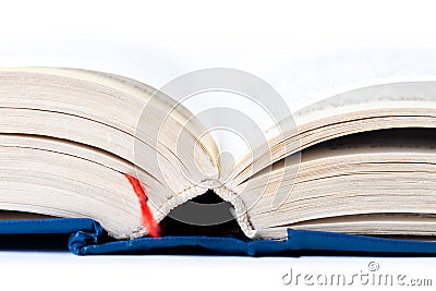 Simple opened empty light blue thick book with red tab, white background, macro, closeup, text blurred. Reading, writing Stock Photo