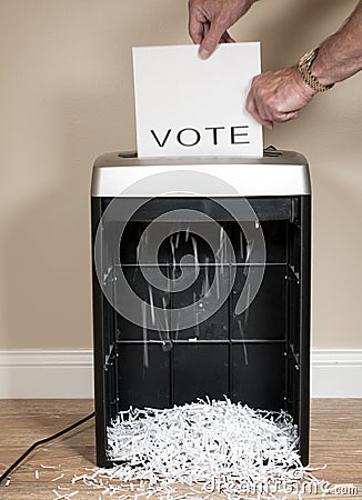 Paper vote being shredded in an office shredder Stock Photo