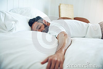 The simple pleasure of sleep. a mature man lying on his bed and sleeping. Stock Photo