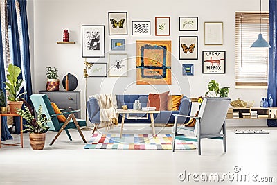 Simple posters gallery hanging on the wall in bright living room Stock Photo