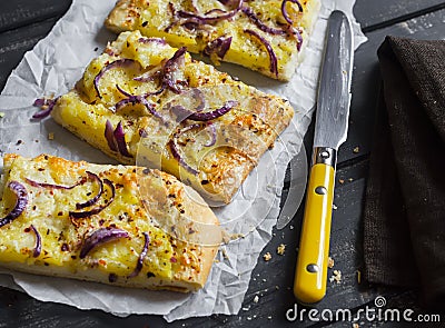 Simple rustic crispy pie with potatoes, cheese and red onion. Stock Photo