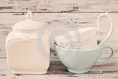 Simple rustic white and blue crockery, empty dishes. Two large bowls each other and porcelain jar with lid. Wooden background Stock Photo