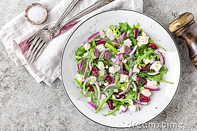 Simple salad with arugula, beans, soft cheese, onions and oil Stock Photo