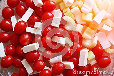 A simple salad for a healthy diet. Cherry tomatoes, celery and slices of cheese. Fresh vegetables for a vitamin diet Stock Photo