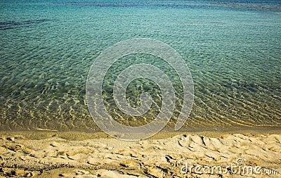 Simple scenery landscape photography of sand stone empty waterfront beach of Mediterranean sea vivid blue wavy water surface Stock Photo