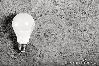 Simple standart form LED energy-saving lamp with E27 screw cap base on gray background with copy space Stock Photo
