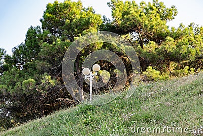 Simple street lights under the open sky. Black metal frame and dusty white glass Stock Photo