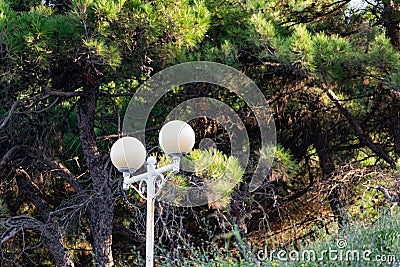 Simple street lights under the open sky. Black metal frame and dusty white glass Stock Photo