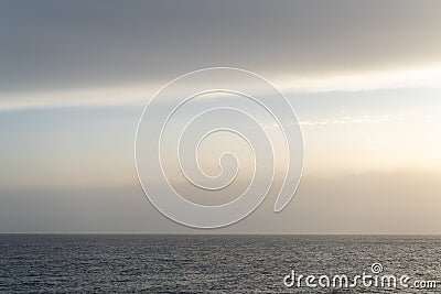 Peaceful and simple view over Mediterranean sea water with rocks and horizon at the end of the day Stock Photo