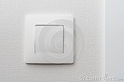 Simple white light switch, turn on or turn off the lights hanging on the white wall in the room Stock Photo