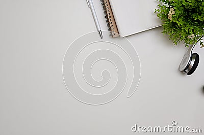 Simple white workspace with stationery, headphones and copy space for text display Stock Photo
