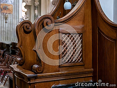 Simple wooden confessional in a church closeup detail, nobody, no people. Confession, confessing sins religious concept Stock Photo
