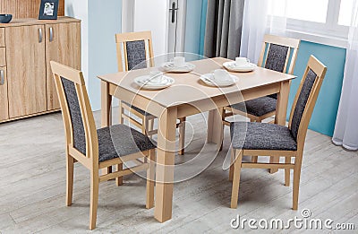 Simple wooden dinning table and chairs in interior - studio Stock Photo