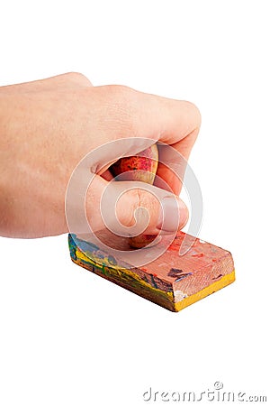 Simple wooden handstamp held in hand, stamp gesture closeup. Hand holding an old worn dirty artsy rubber stamp made of wood Stock Photo