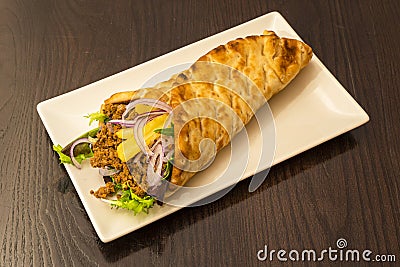 Simplifying a bit, shawarma is the Arabic version of the dÃ¶ner kebab that Stock Photo