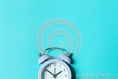Simply minimal design ringing twin bell vintage classic alarm clock Isolated on blue pastel background. Rest hours time of life Stock Photo