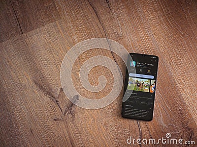 The Sims FreePlay app play store page on smartphone on wooden background Editorial Stock Photo