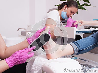 Simultaneous gel polish manicure and pedicure Stock Photo