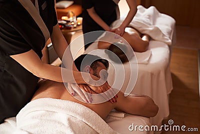 Simultaneous massage for two young people in spa salon Stock Photo