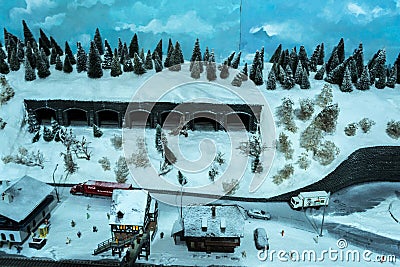 Toy railroad layout with tunnels, building, peoples, car and trucks Editorial Stock Photo