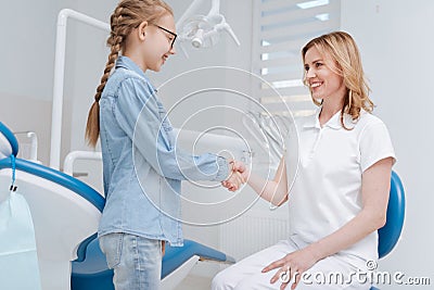 Sincere cute girl meeting her new doctor Stock Photo