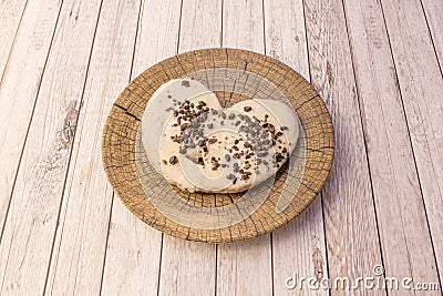 Sinful white chocolate palm tree with oreo cookie shavings on simile wooden plate Stock Photo