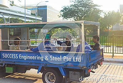 Singapore-29 APR 2018: Indian engineering workers on a truck,under twilight sun shine Editorial Stock Photo