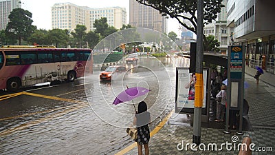 SINGAPORE - APR 2nd 2015: Incredibly strong monsoon rainfall in Asia causing flooding of the street Editorial Stock Photo