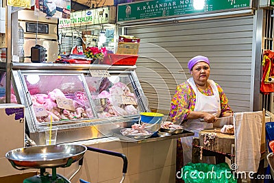 Singapore - 11 2018: Butcher at work at Tekka Indian market Editorial Stock Photo