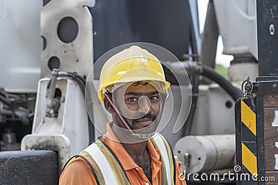 A migrant worker poses for a photo on a city centre construction site in Singapore Editorial Stock Photo