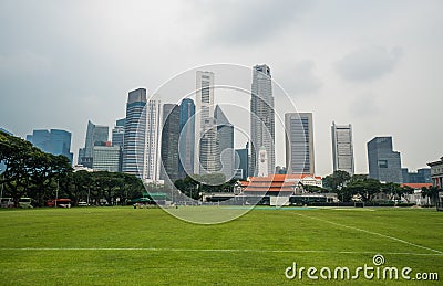 Singapore cityscape with football ground and high commercial buildings Stock Photo